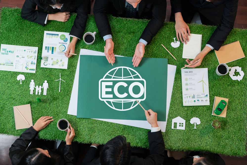 Top view panoramic ECO symbol on grass table with business people. Quaint